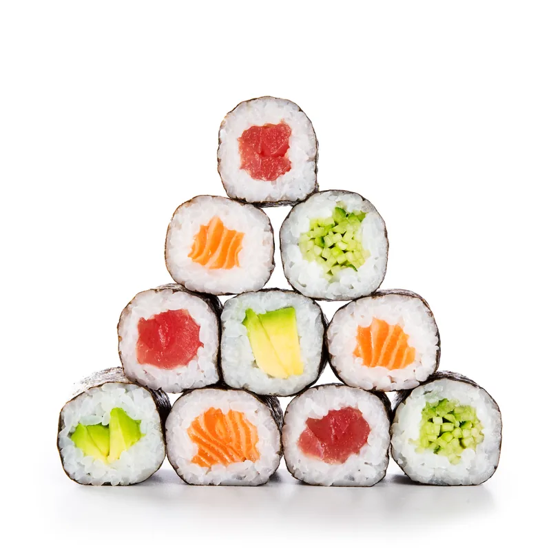 Maki rolls stacked in a pyramid on a white background